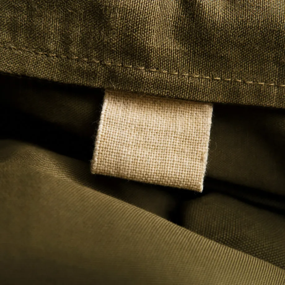 Macro detail of a fabric size label on a folded garment.